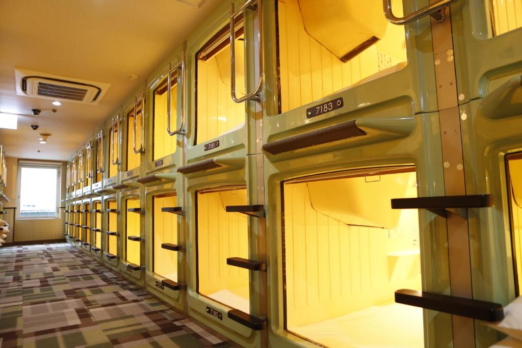 Narrow corridor lined with capsule openings and numbered panels
