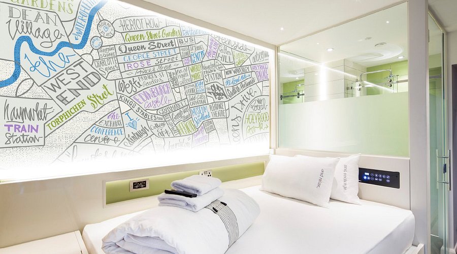 Small standardised bedroom with a fitted bed, wall panel and narrow window