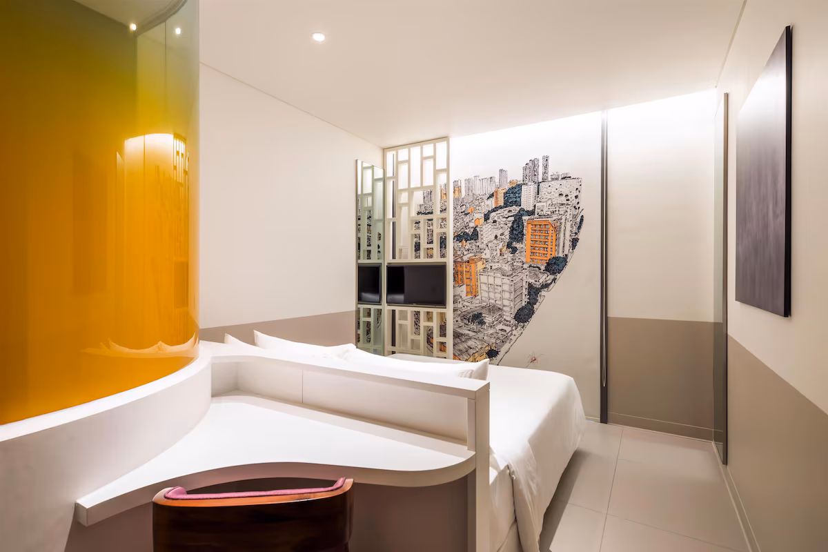 Compact standardised bedroom with a window seat and a wall-hung desk
